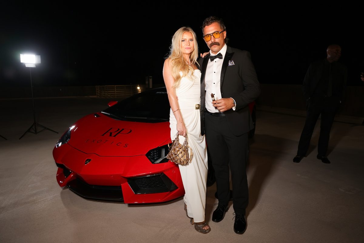 Couple beside a red Lamborghini at the RP Exotics gala