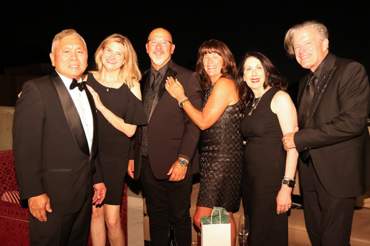 Group of friends celebrating together at the gala