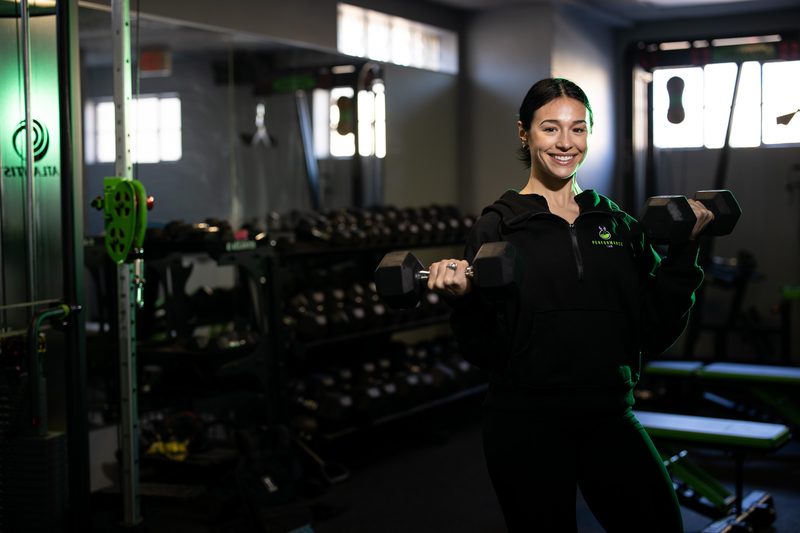 Environmental portrait of a male trainer in a fitness gym
