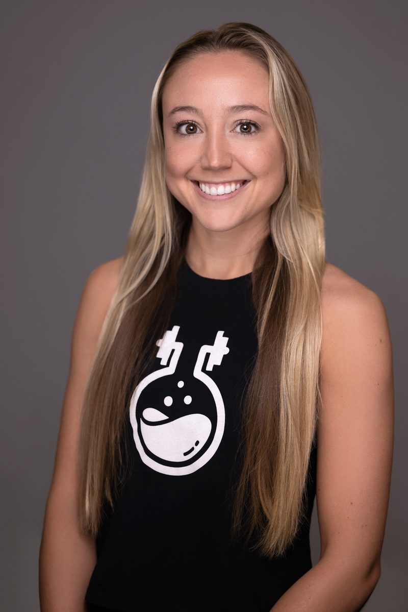 Studio headshot of a blonde woman on a white background
