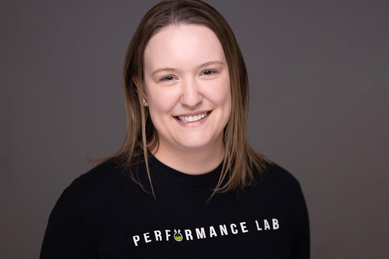 Branded team portrait of a woman in a Performance 150 shirt
