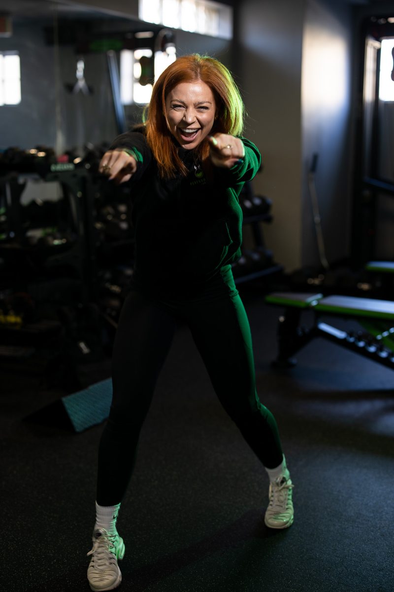 Environmental fitness portrait of a woman holding gymnastic rings