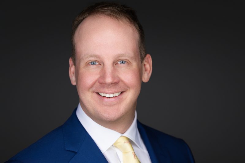 Executive headshot on dark background