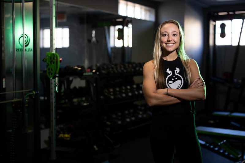 Environmental portrait of a blonde woman in a fitness gym